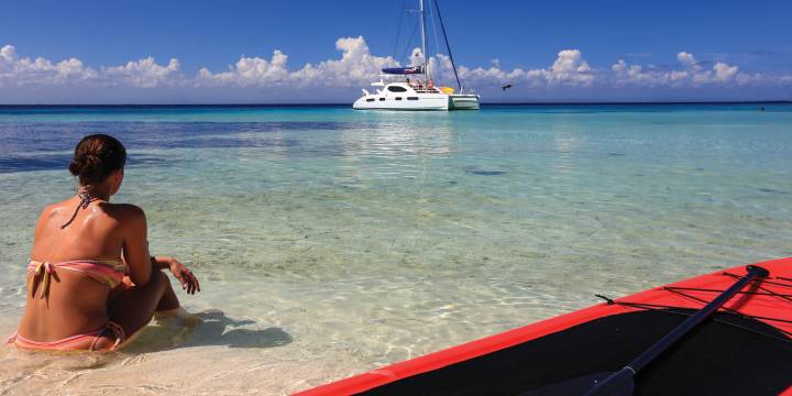 Woman sitting on beach in Belize